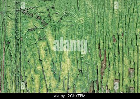 texture of a green painted wooden door, with the paint deteriorated by the effects of time, with a few flaking marks, horizontal Stock Photo