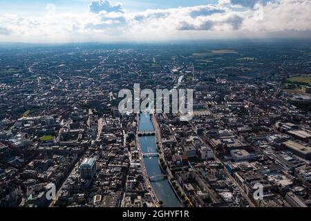 Aerial view of skyline of Dublin with river flowing with bridge connecting two sides of street surrounded by buildings during a cloudy day Stock Photo