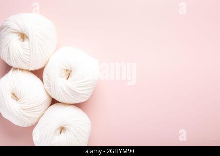 White clews of wool on a pink background. Place for your text. Top view - Image Stock Photo