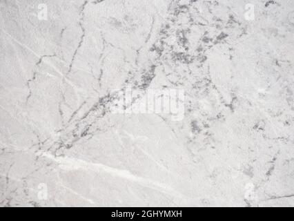 Natural white marble with large black veins, close-up of light stone surface. Background, pattern, texture. Stock Photo