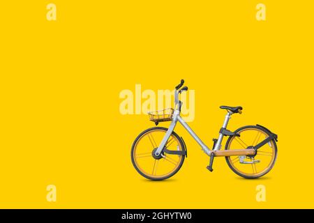 Bicycle on vivid yellow color background Stock Photo