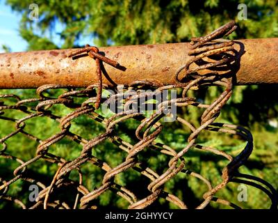 Old rusty metal mesh fence outdoor,abstract background Stock Photo