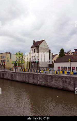 Brussels, Belgium - June 16, 2013: A narrow abandoned house at the Brussels Canal in Brussels on a cloudy summer day. Stock Photo