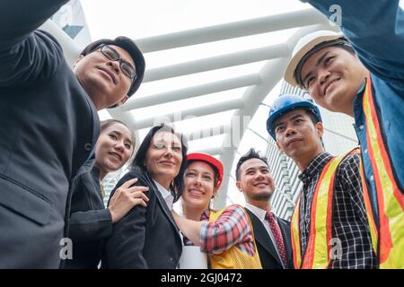 Cheerful Multiethnic colleague of various occupation selfie a photo together in urban Stock Photo