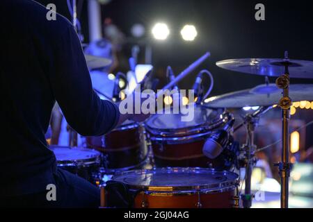 Drummer is playing the drums on stage at the event Stock Photo