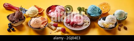 Gourmet selection of creamy Italian ice-cream in assorted fruity and chocolate flavors served in individual dishes with fresh ingredients on a colorfu Stock Photo