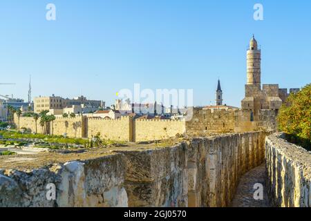 View of the Ramparts Walk, over the old city walls, with the Tower of David (Citadel) and other monuments, in Jerusalem, Israel Stock Photo
