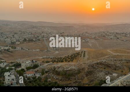 Sunrise view towards the Judaean desert and the Dead Sea, with a herd of sheep and Palestinian villages. From Herodium, the West Bank, South of Jerusa Stock Photo