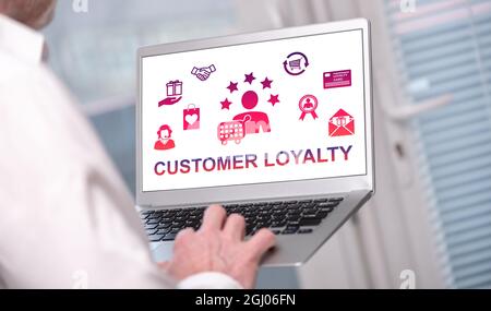 Customer loyalty concept shown on a laptop used by a man Stock Photo