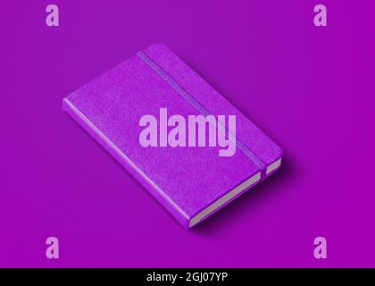 Purple closed notebook mockup isolated on color background Stock Photo