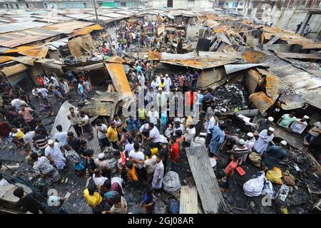 Non Exclusive: DHAKA CITY, BANGLADESH - SEPTEMBER 6: Persons are seen after the fire that broke out at Keraniganj's Noor Super Market last night. At l Stock Photo