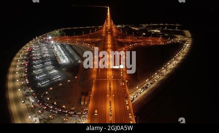 Kuwait City. 7th Sep, 2021. Aerial photo taken on Sept. 7, 2021 shows cars lining up on the road near a drive-thru vaccination center to receive COVID-19 vaccine in Kuwait City, Kuwait. Credit: Asad/Xinhua/Alamy Live News Stock Photo