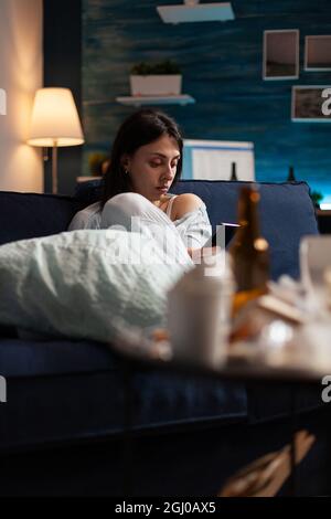 Disappointed, depressed, annoyed, unhappy woman reading eviction notice digital bank report using phone. Shocked, anxious female tenant by warning notification for unpaid bills Stock Photo