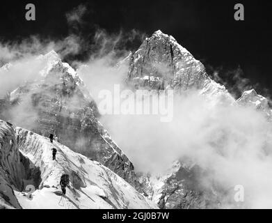 Mount Lhotse with clouds on the top - way to mount Everest base camp, Khumbu valley, Sagarmatha national park, Nepalese Himalayas mountains, black and Stock Photo