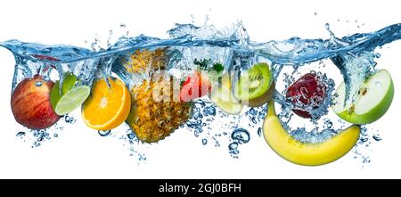 various fresh colorful tasty fruits splashing into cold water isolated on white background. food diet healthy eating freshness concept Stock Photo