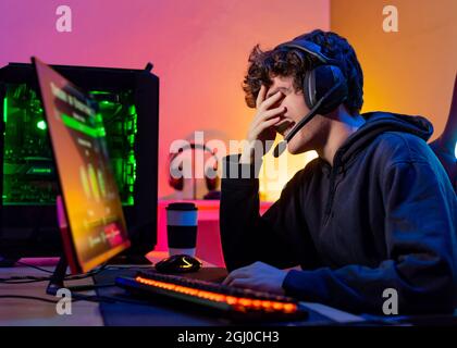 Laughing man playing video game on computer Stock Photo