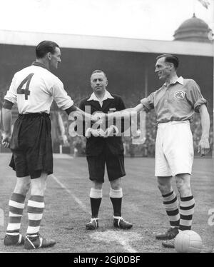 1950 FA Cup Final Arsenal v Liverpool Joe Mercer (right) Arsenal captain and left half, shakes hands with Liverpool captain, and right half, Phil Taylor before the kickoff in the FA Cup final at London's Wembley Stadium. Watching is referee Harry Pearce 29th April 1950 Stock Photo