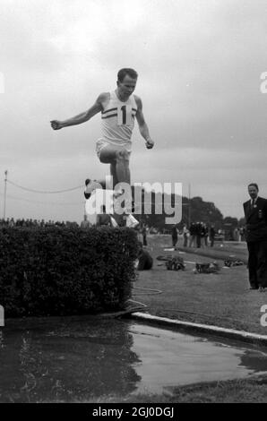 Chris Brasher who has been chosen for the 3000 metres steeplechase at the Melbourne Olympics seen taking a water jump London 21st August 1956 Stock Photo