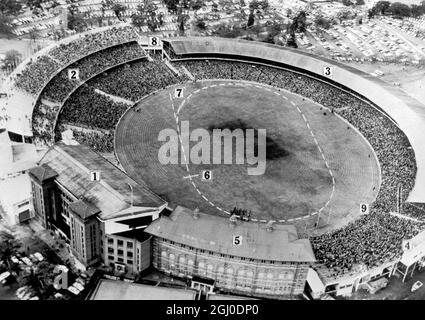 The Melbourne cricket ground was the main stadium for the 1956 Olympic Games which accomodated 100,373 people for the event. The picture shows a crowd of 80,000 at the first semi-final of the Australian Rules Football competition.The impressive new stand (at left numbered 2) was open to the public for the first time. It is in this stand that the Royal Box was situated, opposite the centre of the running track. 18th September 1956 Stock Photo