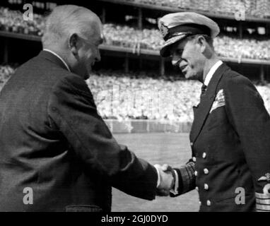 Melbourne Olympic Games 1956 The Duke of Edinburgh shakes hands with Australian Prime Minister Robert Menzies during the opening ceremony of the XVIth Olympiad in the Melbourne Cricket Ground. 22nd November 1956 Stock Photo