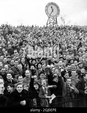 Scenes form Highbury Stadium soon after the gates were opened to let in the thousands who had jam-packed all the surrounding streets for the third round cup tie between Arsenal and Spurs. 8th January 1949. Stock Photo