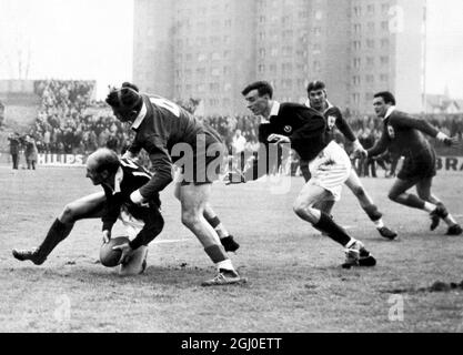 All running in for the tackle from left to right are:Robson of Scotland; Mias of France; Brown of Scotland; Mommejat of France and Celaya of France, during the France v Scotland rugby match at the Colombes stadium in Paris. France won by nine points to nil in their first match of the Five Nations tournament. 10th January 1959. Stock Photo