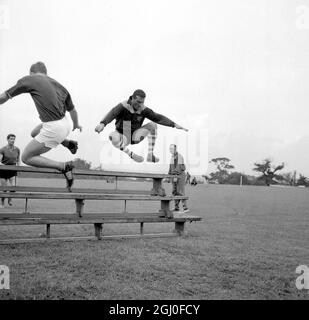 Noel Cantwell, captain of West Ham United Football Club, clears three benches piled on top of each other at the club's training ground in Chigwell, Essex during training for the 1960-61 season. 10th August, 1960. Stock Photo