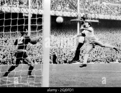 1966 World Cup Portugal v Brazil Eusebio scores Portugal's second goal with his head during the World Cup match against Brazil at Goodison Park. Brazilian players are Orlando and the goalkeeper Manga (No.12). 19th July 1966. Stock Photo