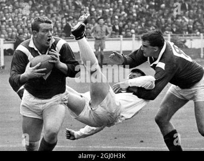 Bill Sayer, The ST. Helen's hooker ends up in mid air after attempting to stop Wigan's left centre three-quarter and skipper Eric Ashton during the Rugby League Challenge Cup Final at Wembley Stadium this afternoon (Saturday). Other Wigan player in the picture is front row forward Danny Gardiner. 1966 Stock Photo