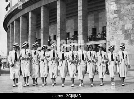 1936 Olympics, Berlin - The Olympics are a big experience for these young sportswomen of the world. This picture shows the Hungarian athletes, chipper, fresh and laughing, arm in arm outside the Olympic stadium. (Fur die jungen Sportlerinnen aller Lander waren die Olympischen Spiele ein grosses Erlebnis. Dieses Bild zeigt die ungarischen Leichtathletinnen Arm in Arm unter dem Saulengang des Olympiastadions; - frolich und frisch lachen sie in diese Welt.) ©TopFoto Stock Photo