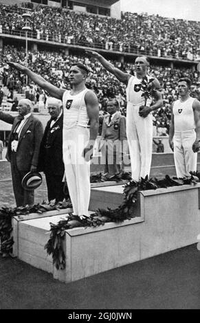 1936 Olympics, Berlin - Gymnastics men's vault winners: 1. Karl-Alfred Schwarzmann (Germany - centre), 2. Eugen Mack (Switzerland - right), Matthias Volz (Germany - left). ©TopFoto Stock Photo