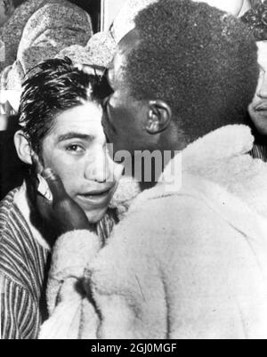 Wrigley Field , Los Angeles . Hogan ' Kid ' Bassey of Nigeria the World Featherweight Champion was restrained by referee after the former had floored Ricardo ' Little Bird ' of Liverpool in the third round . The count ended with only seconds of the round to go . Bassey planting a kiss on forehead of Ricardo 3 April 1958 Stock Photo