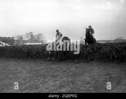 Jay Trump (right) with American amateur jockey , Crompton ( Tommy ) Smith 27 up takes the last fence of the Grand National to go on to win the race . Second was Freddie ridden by Pat McCarron , Aintree , Liverpool , England . 27 March 1965 Stock Photo