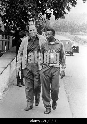 Knee treatment for Pele . Liverpool , Lancs , England ; Dr Hilton Gosling , Brazil ' s team doctor is pictured with Pele ( right ) after and hour ' s treatment on his knee following the close attention paid to Pele during the Bulgarian - Brazil World Cup game at Everton Football Club on 12th July , when Brazil won 2 - 0 . 14 July 1966 Stock Photo