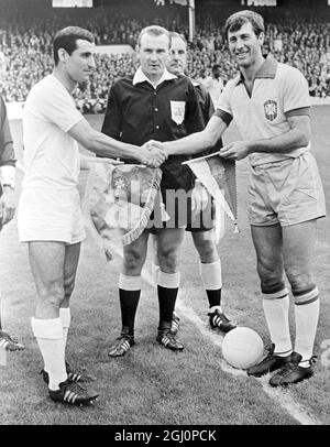 Friendly meeting . Liverpool , England : This picture shows the Bulgarian Captain ( left ) and the Brazil captain shaking hands and exchanging pennants before the start of last night ' s World Cup match which Brazil won 2 - 0 . 13 July 1966 Stock Photo