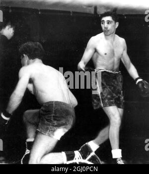 Down on one knee goes Luis Romero , the Spanish champion , who was making a bid to wrest the world bantamweight title from the holder , Vic Toweel (right) , Johannesburg , South Africa . The championship was retained by Toweel , who won the 15 round contest with a decisive points win . 20 November 1950 Stock Photo