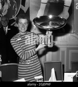 Sportswoman of the year. Yorkshire's world champion woman cyclist Beryl Burton holds aloft the Daily Express Sportswoman of the Year Trophy, she received at a lunch at the Savoy Hotel today. The 32-year-old housewife won the women's world road racing championship in September to cap a wonderful season in which she broke every record in England. She was top of the poll among readers of newspaper. 8 November 1967 Stock Photo