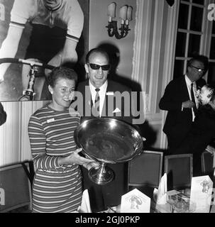 Henry Cooper with a Sportswoman of the Year. Henry Cooper, with dark glasses, covering the only signs of damage from his battle with Billy Walker last night, and admires the trophy won by World Champion woman cyclist Beryl Burton as the Daily Express Sportswoman of the Year. Sportsman of the year, showjumper Harvey Smith, and Beryl were presented with their awards at lunch at the Savoy Hotel today. 8 November 1967 Stock Photo