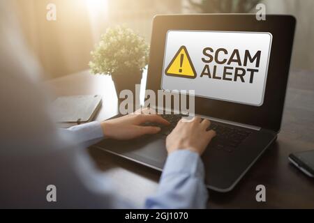 Scam alert detecting warning. Notification on device screen Stock Photo