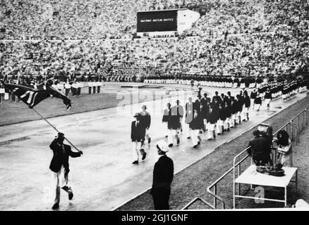 BRITAIN ' S TEAM AT OPENING OF 1952 OLYMPIC GAMES Helsinki : The British Olympic team , led by standard - bearer Harold Whitlock , the 1936 Olympic walking champion , parading round the stadium at the opening of the 1952 Olympic Games . Over 6,000 athletes from 70 nations will be competing in the Games . 19th July 1952 Stock Photo