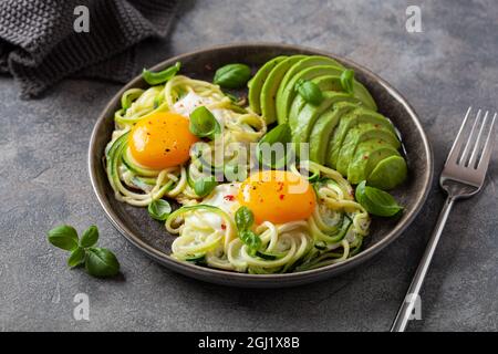 keto low carb breakfast baked spiralized zucchini with eggs and avocado Stock Photo