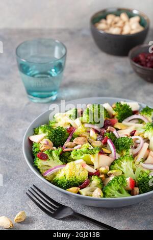 healthy broccoli salad with apple onion dried cranberries pistachio. vegan low carb diet Stock Photo