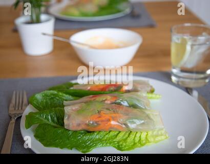 Spring rolls on the plate. Healthy vegetarian food. Vegan. Rice paper and veggies with mayonnaise Stock Photo