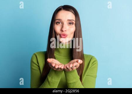Portrait of attractive cheerful sweet amorous girl sending you air kiss isolated over bright blue color background Stock Photo