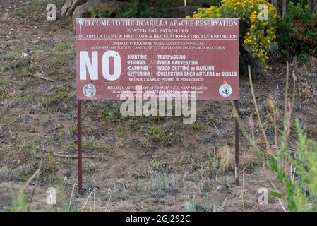 Welcome sign to the Jicarilla Apache Reservation, Dulce, New Mexico, with a list of rules like no hunting, no camping, no trespassing and no fishing. Stock Photo