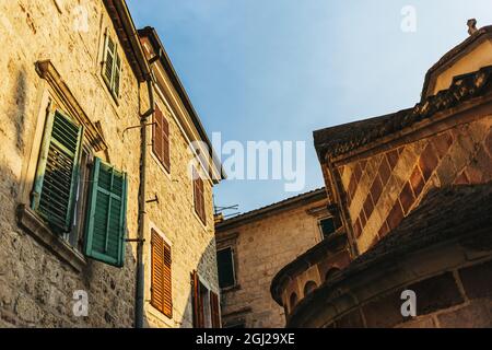 Beautiful old street in Kotor, Montenegro. Old buildings of Kotor. Amazing sunlight. Stock Photo