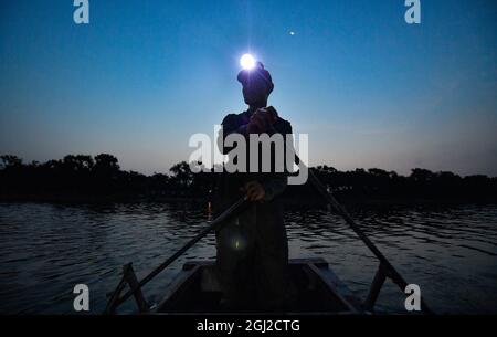 (210908) -- TIANJIN, Sept. 8, 2021 (Xinhua) -- A villager goes fishing on the Chaobai River to prepare ingredients for agritainment business in Xiaoxinmatou Village of Baodi District in Tianjin, north China, Sept. 3, 2021. Li Chao is a post-90s born in Xiaoxinmatou Village in Baodi District. Located by the Chaobai River, the village used to witness an outflow of young people, as villagers made a living by traditional fishing and farming with low income. Like his young fellows, Li chose to be a migrant worker in the city for higher income. Waiter, chef, assembly line worker, security guard Stock Photo