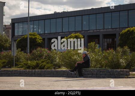 An old man talking on the phone about his business. Working old man managing his business by phone. Stock Photo