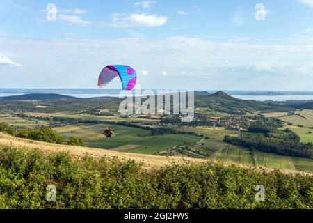 Paraglider over the mountains of lake Balaton in Hungary on a summer day. Stock Photo