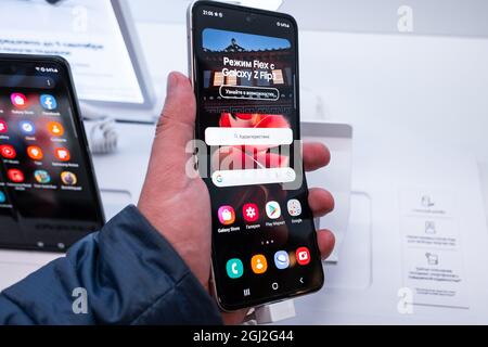 September 2, 2021, Moscow, Russia. New bendable smartphone from Samsung Galaxy Z Flip 3 on a storefront. Stock Photo